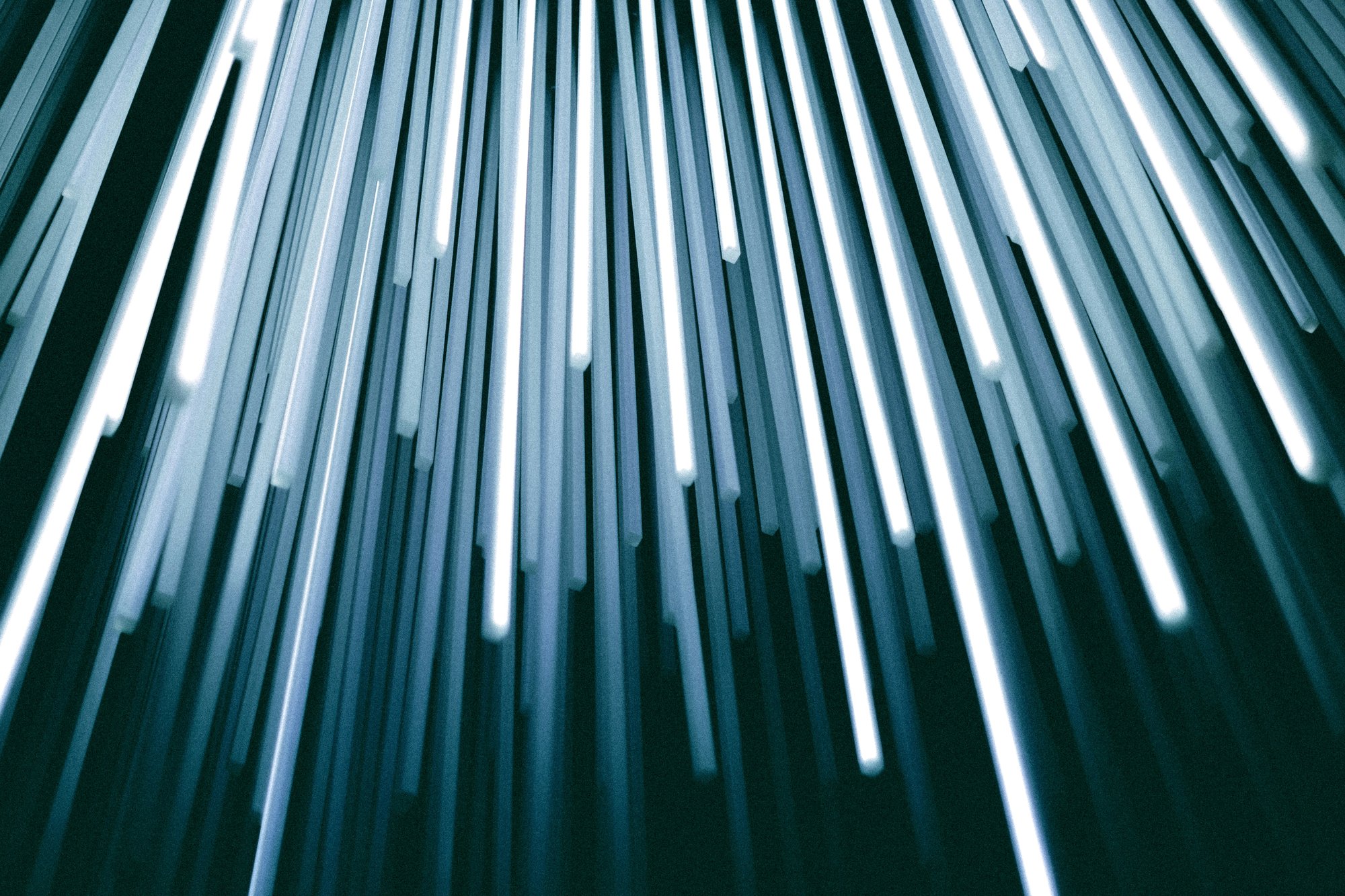 Abstract vertical light beams or data streams in motion, representing speed, security, and continuous data flow.